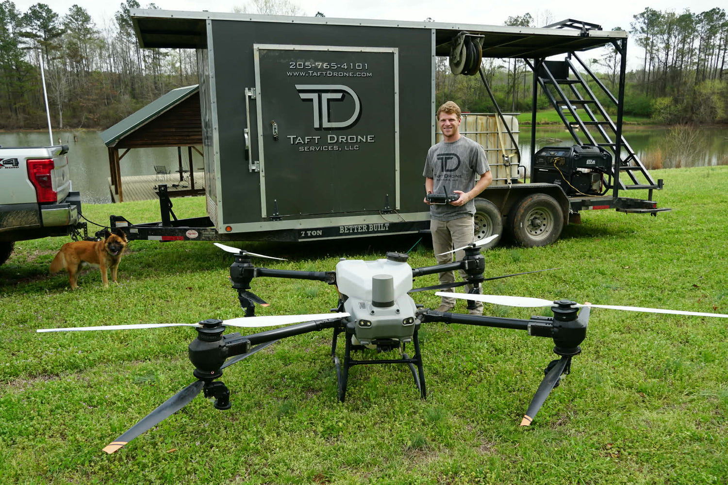 trayton taft of traft drones poses with a large drone and trailor